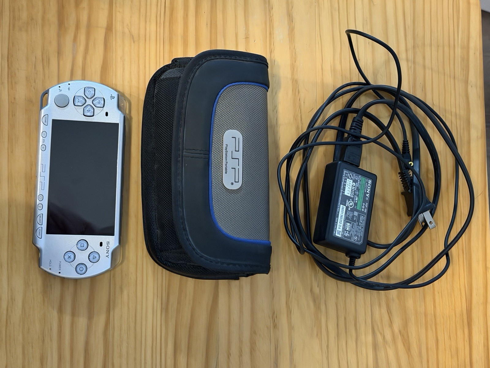 Sony PSP-2001 Handheld Console Bundle w/ Case, AC Adapter, 2 games, 1 GB memory