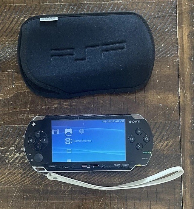 Sony PSP-1001 Console, 2 Batteries w/Charger, 4 Games, 2 Movies, Family Guy 1&2