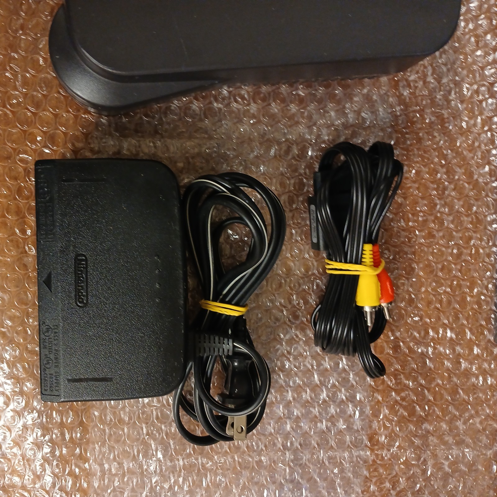 Nintendo 64 with expansion pak, power & AV cords, & one controller.