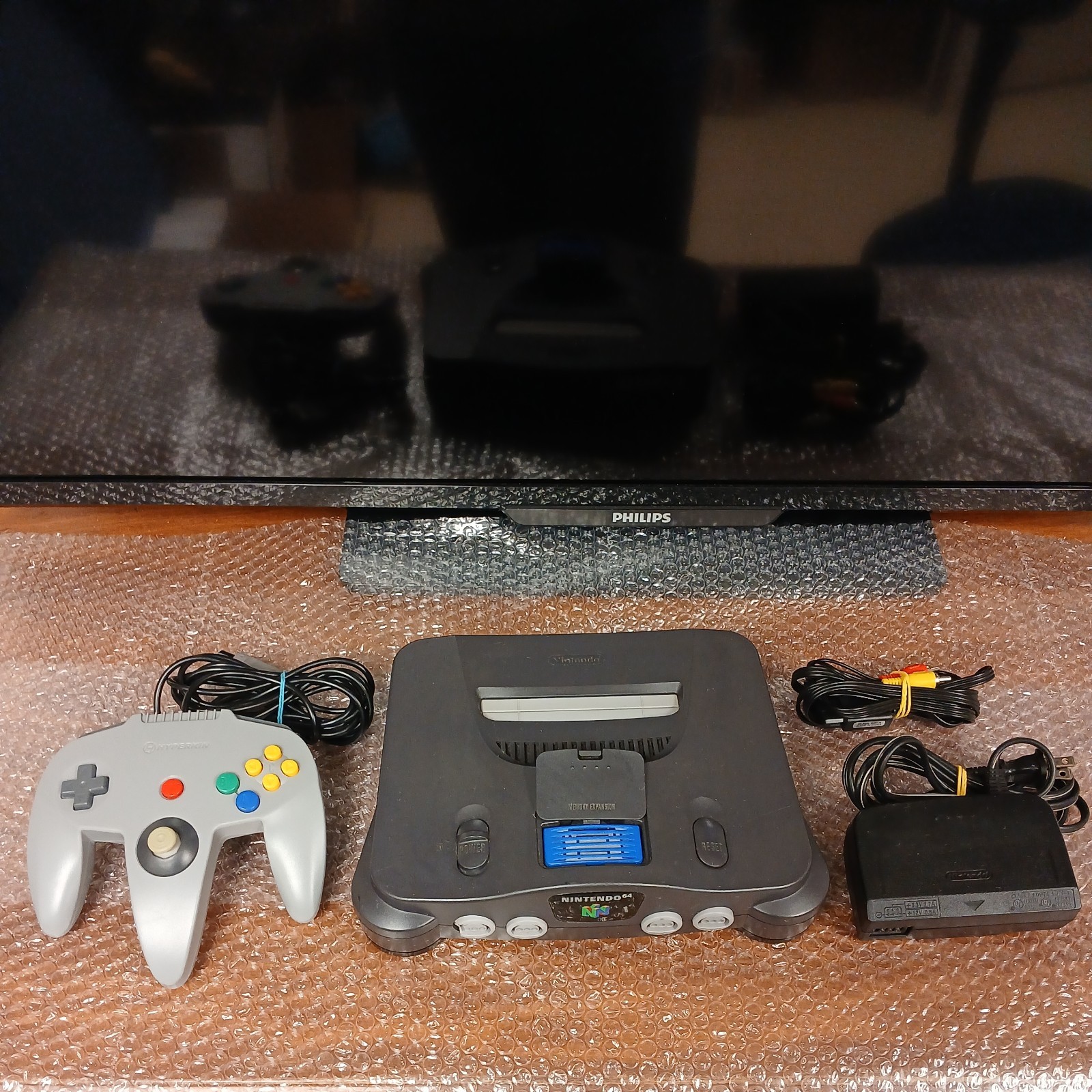 Nintendo 64 with expansion pak, power & AV cords, & one controller.