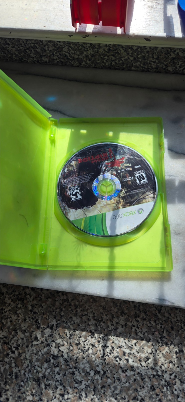 pre-owned copy of the video game Dead Island: Riptide for the Xbox 360 platform
