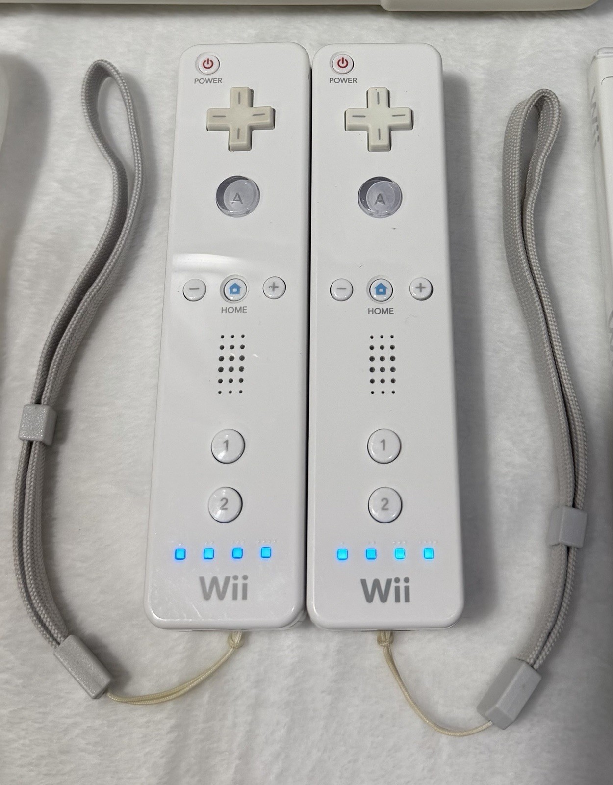 Nintendo Wii console with 2 remotes, 1 silicone sleeve & Nerf sports attachments