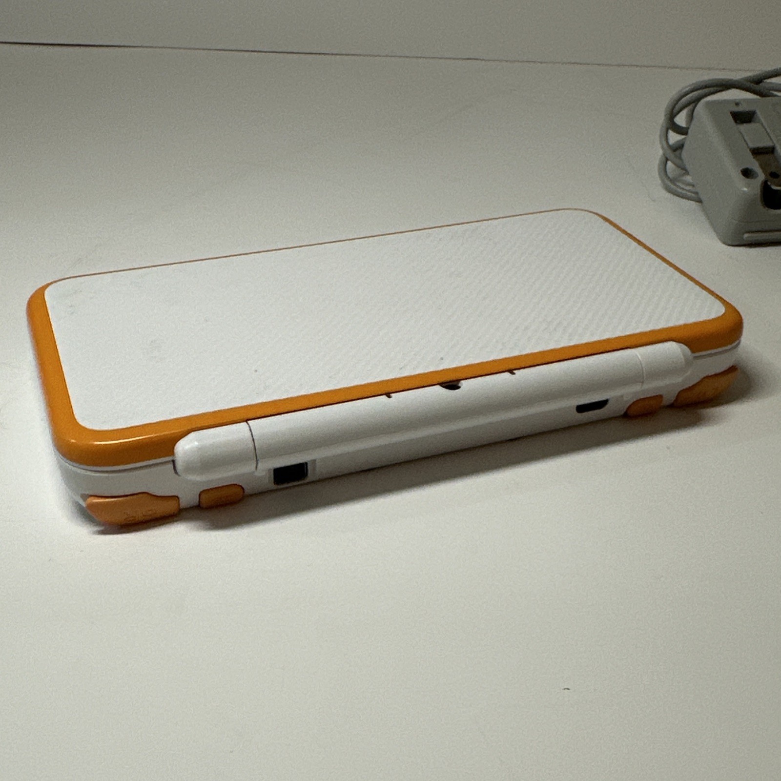 Nintendo 2DS XL – Orange & White Bundle (Top Screen Crack/ Non-OEM Charger)