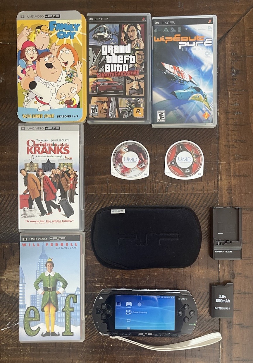 Sony PSP-1001 Console, 2 Batteries w/Charger, 4 Games, 2 Movies, Family Guy 1&2
