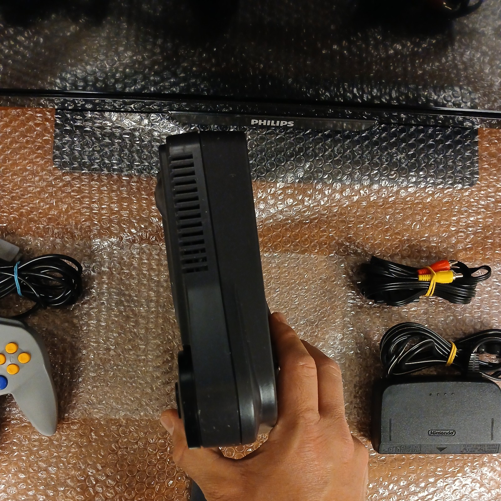 Nintendo 64 with expansion pak, power & AV cords, & one controller.