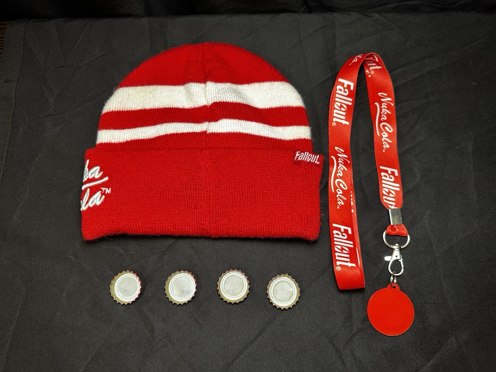 Lot of Bethesda Fallout Nuka Cola Bottle Caps, Beanie Hat, Lanyard & Keychain