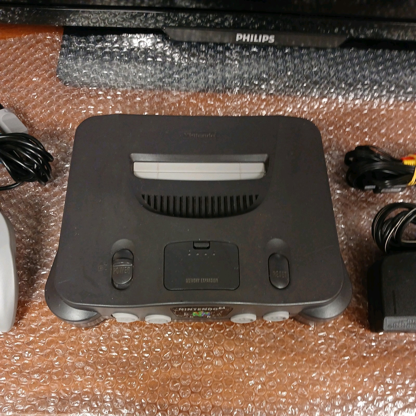 Nintendo 64 with expansion pak, power & AV cords, & one controller.