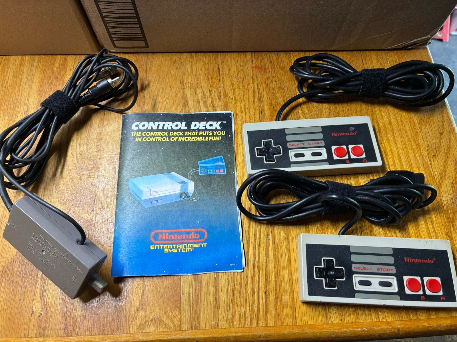 2 Vintage Nintendo NES OEM Controllers, RF Adapter, And Manual.