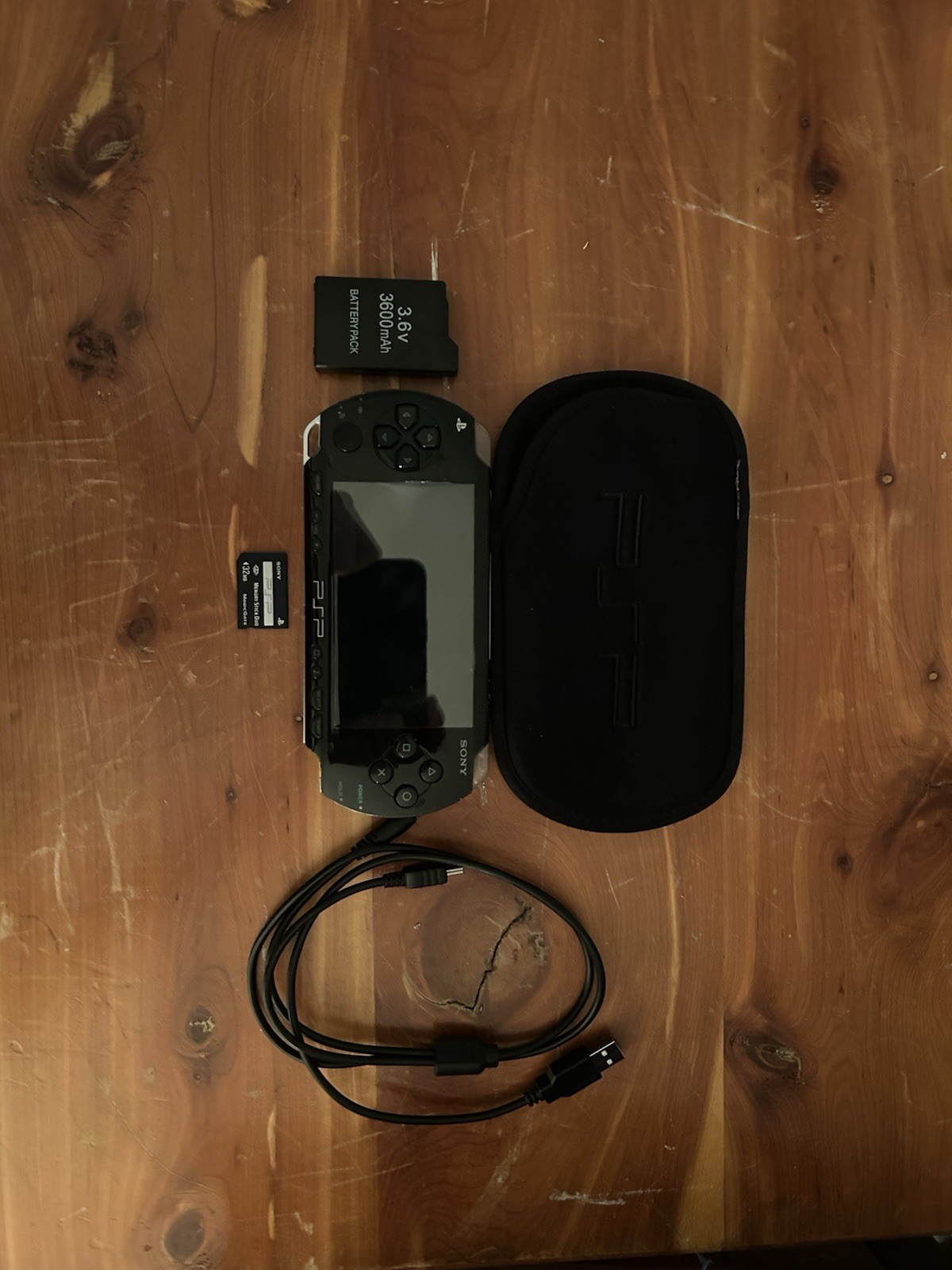 Black Sony PSP With 32mb memory card, charger, and cover