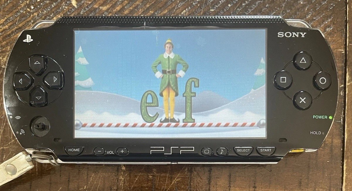 Sony PSP-1001 Console, 2 Batteries w/Charger, 4 Games, 2 Movies, Family Guy 1&2