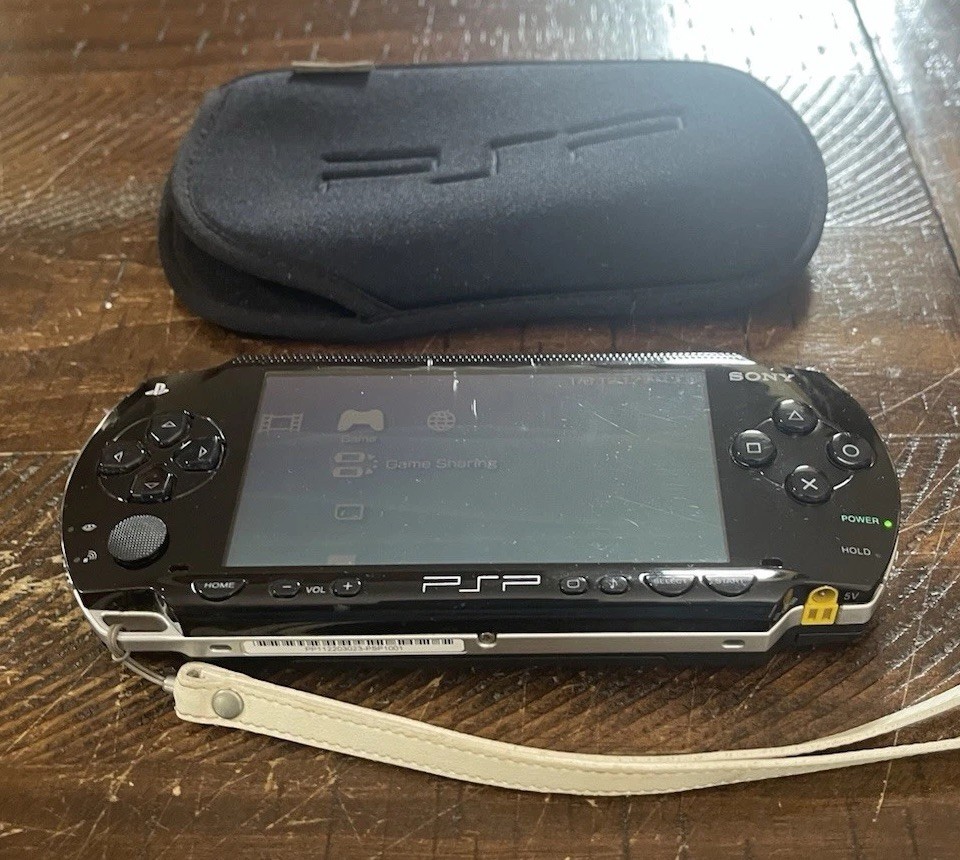 Sony PSP-1001 Console, 2 Batteries w/Charger, 4 Games, 2 Movies, Family Guy 1&2