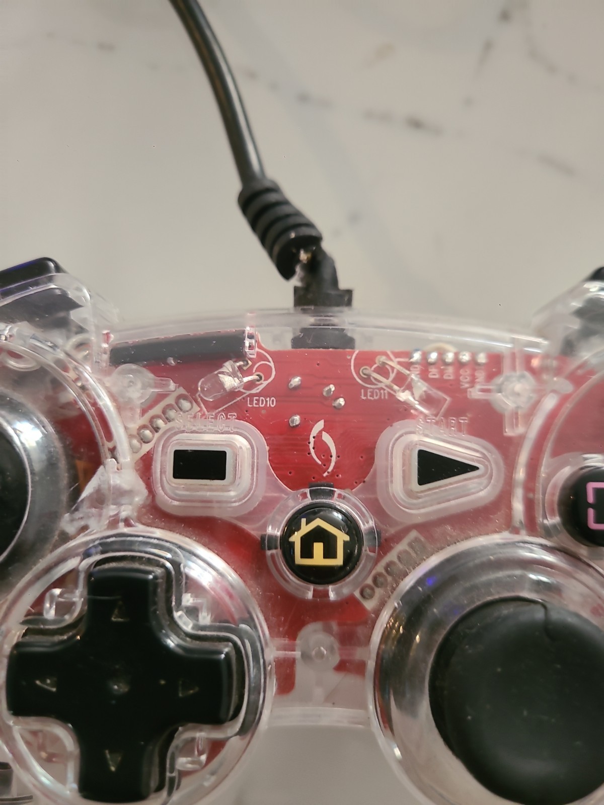 Third-party wired gaming controller for PlayStation 3, transparent pink…