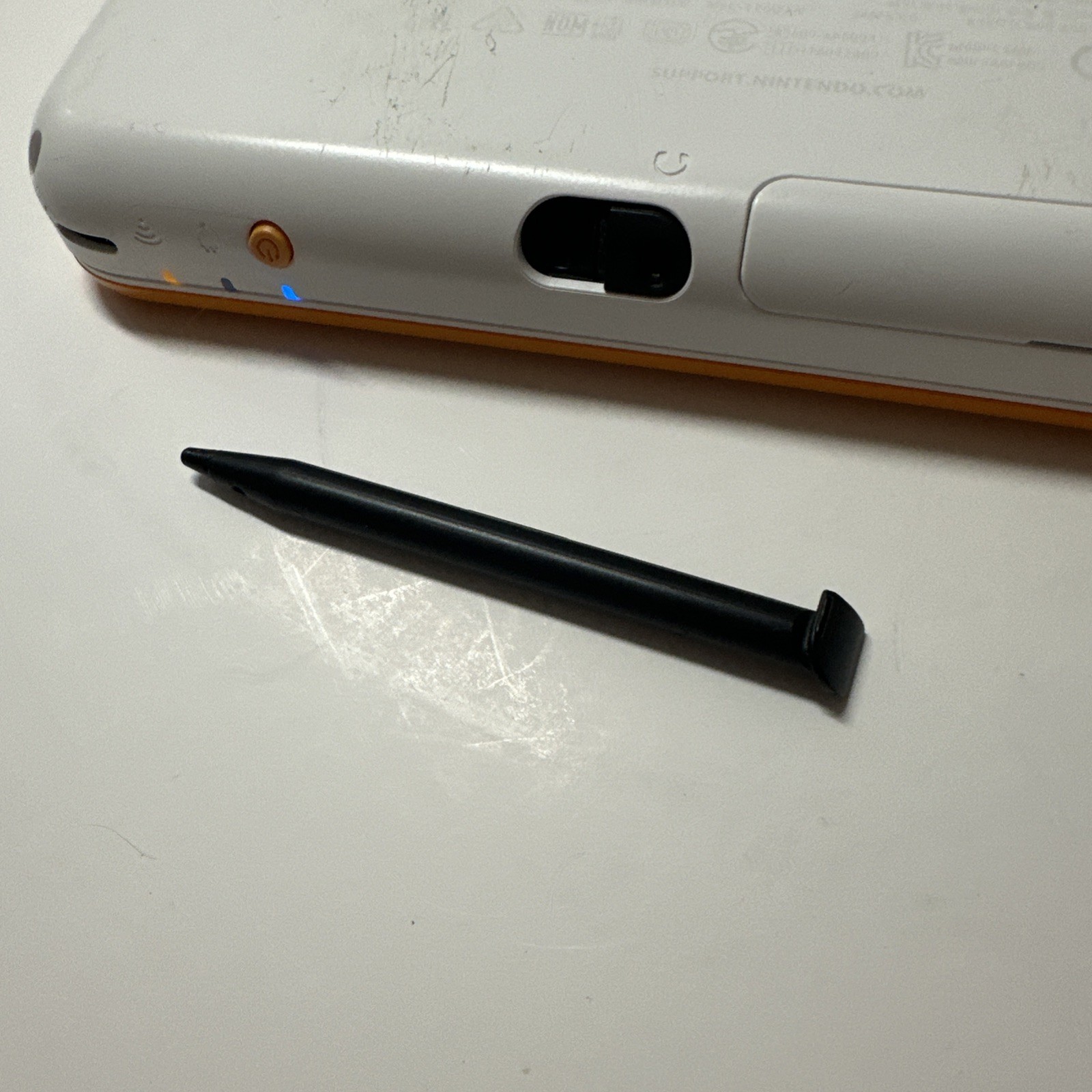 Nintendo 2DS XL – Orange & White Bundle (Top Screen Crack/ Non-OEM Charger)