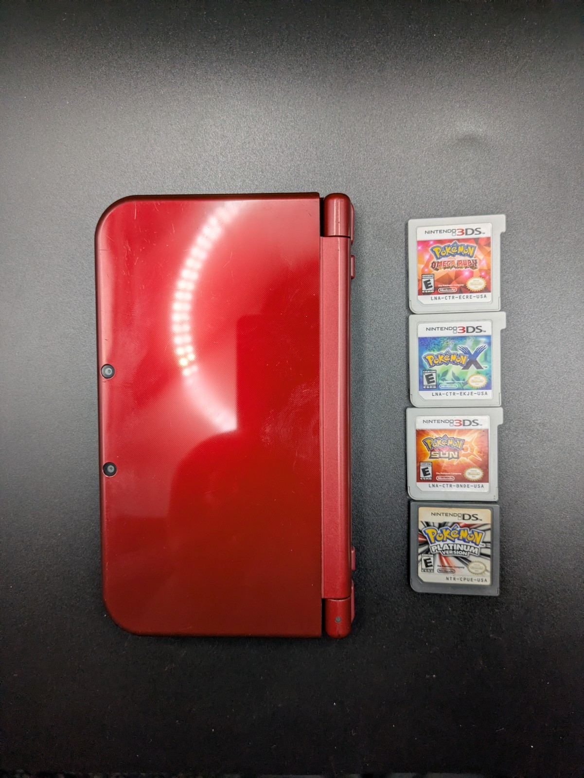 Nintendo New 3DS XL Red Console Bundle w/ Pokemon Platinum, Sun, X, Omega Ruby