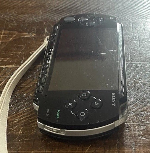 Sony PSP-1001 Console, 2 Batteries w/Charger, 4 Games, 2 Movies, Family Guy 1&2