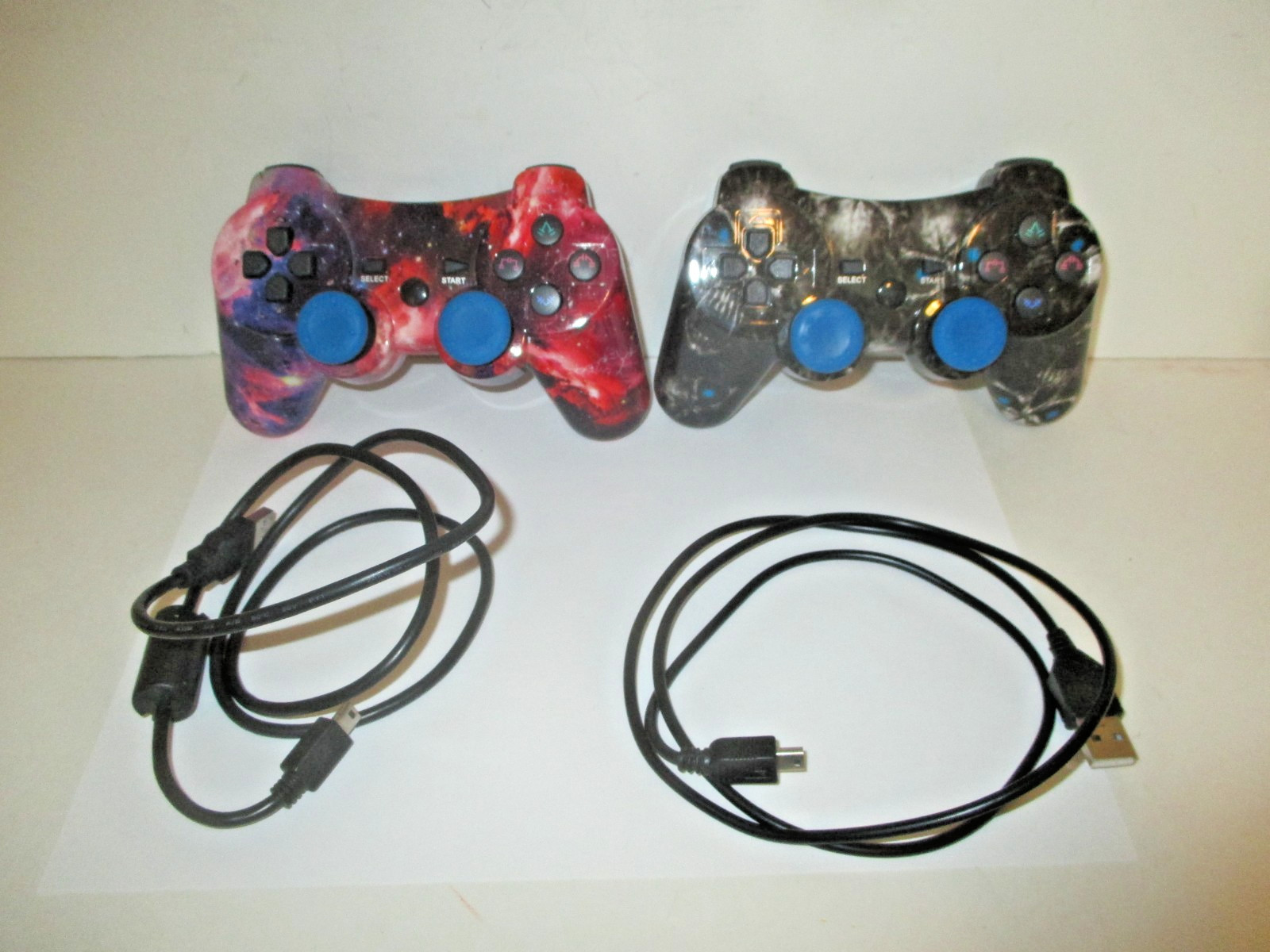 PAIR PLAYSTATION 3 PS3 3RD PARTY CONTROLLERS BLACK SKULL RED COSMOS+CORDS AS IS