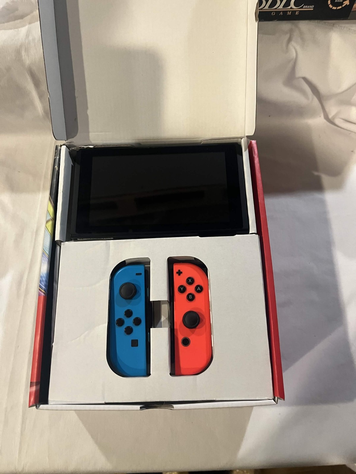 Nintendo Switch with accessories and box with red and blue joy cons