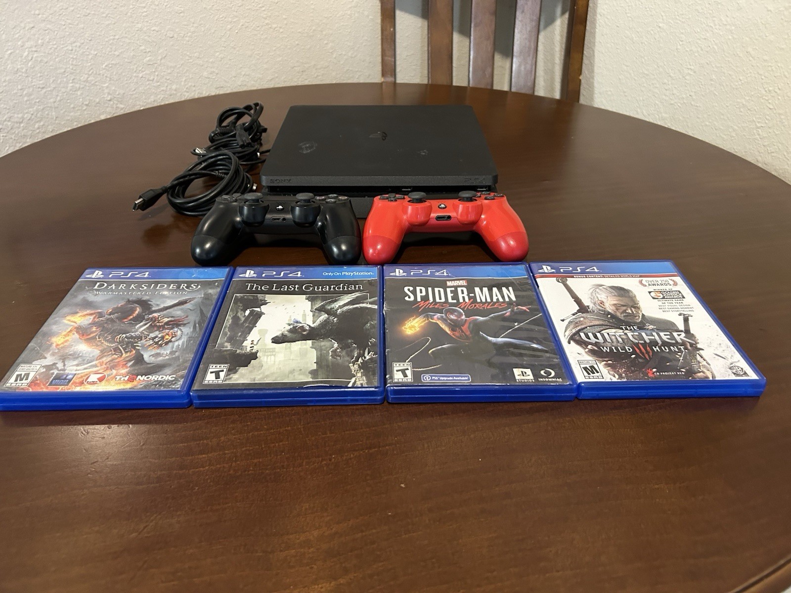 PS4 Slim 1TB Console W/ 2 Controllers, 4 Games