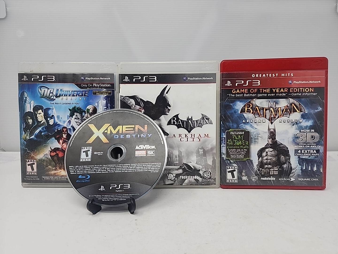 PS3 Lot Of 4 – X-Men: Destiny, Batman Arkham City & Asylum, & DC Universe Online