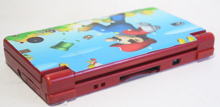 Nintendo DSi Red Handheld Game Console w/ Mario Skin Cover + Super Mario DS Game