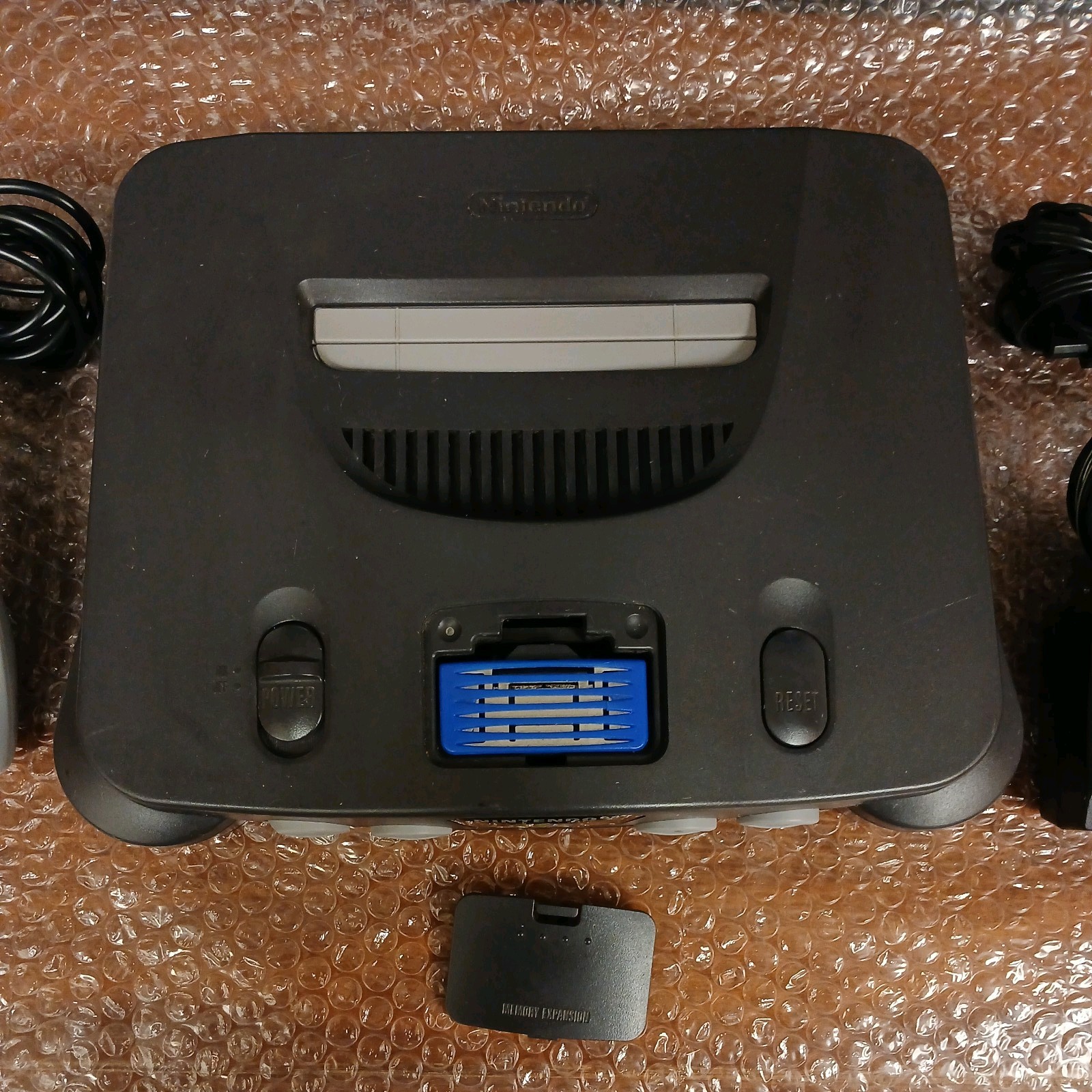 Nintendo 64 with expansion pak, power & AV cords, & one controller.