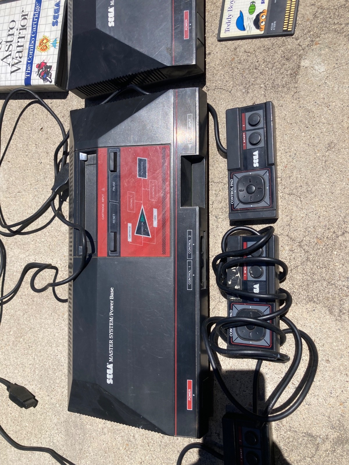 2 sega master system consoles with 3 controllers and games (not sure if it works