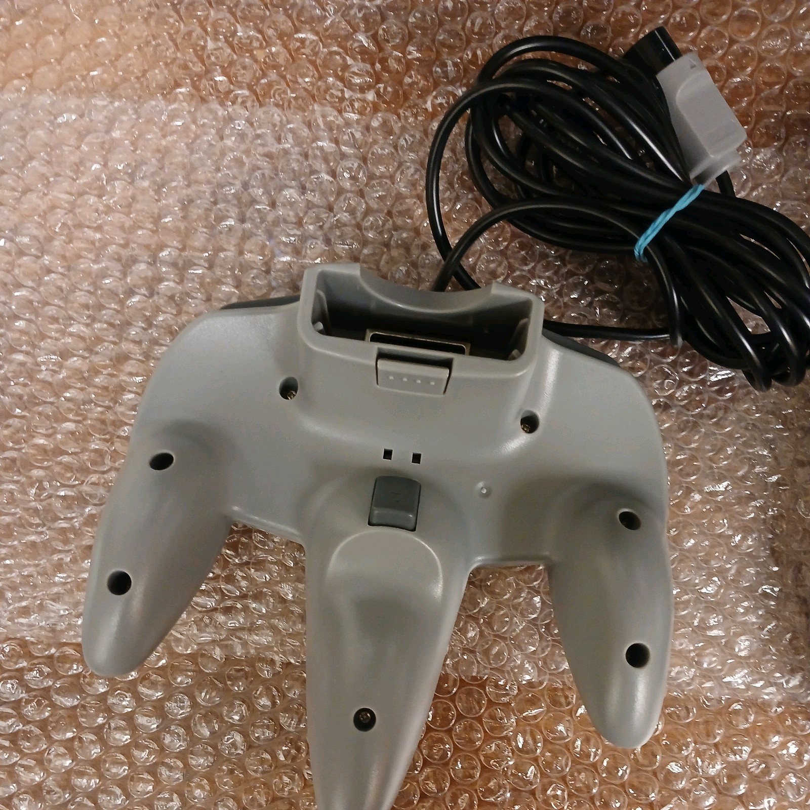 Nintendo 64 with expansion pak, power & AV cords, & one controller.