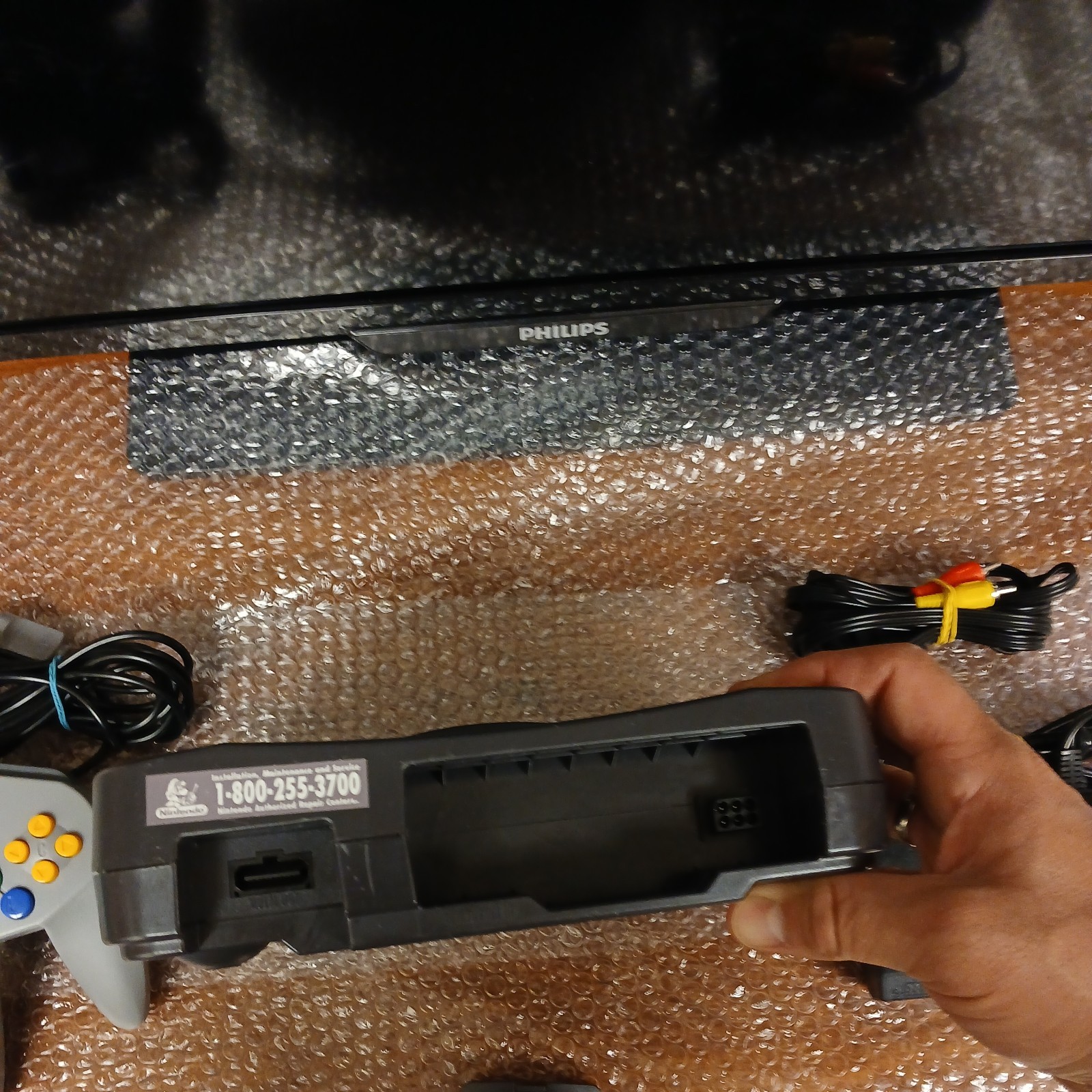 Nintendo 64 with expansion pak, power & AV cords, & one controller.