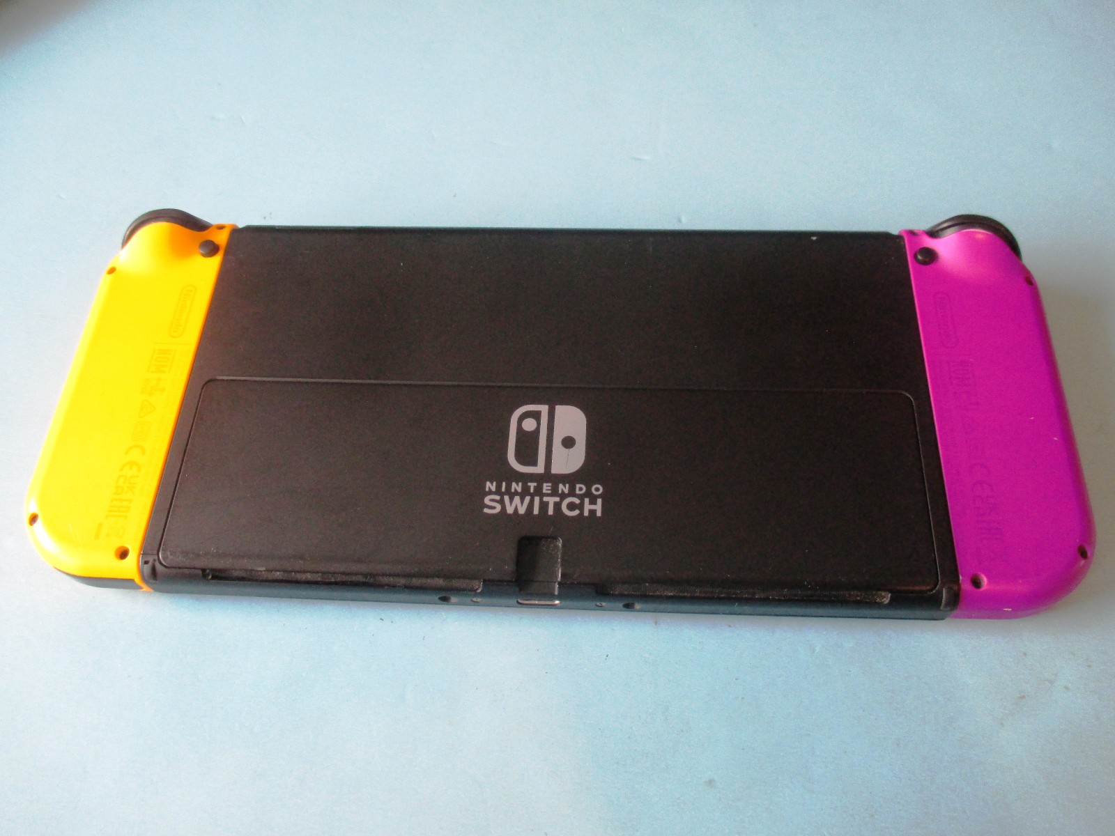 Nintendo Switch OLED System Black Console w/Purple & Orange Joy-Cons + Case