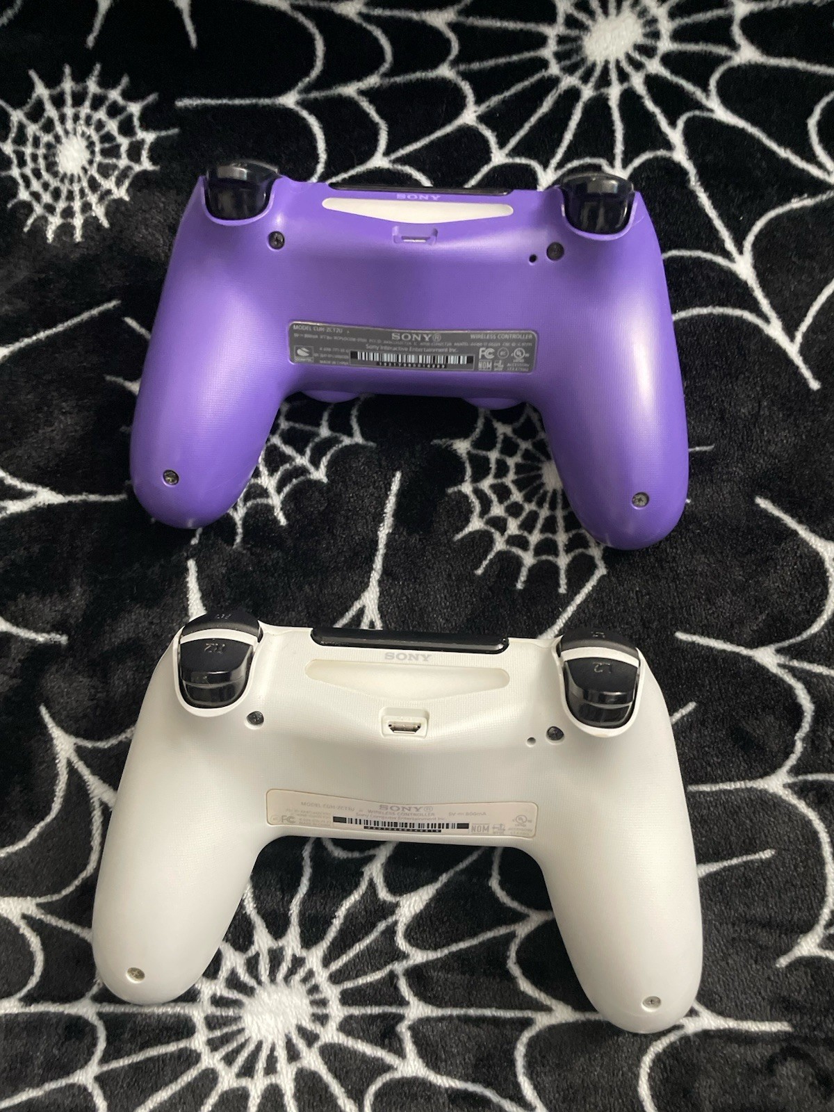 Sony PlayStation Black PS4 and White and Purple Wireless Controllers Bundle