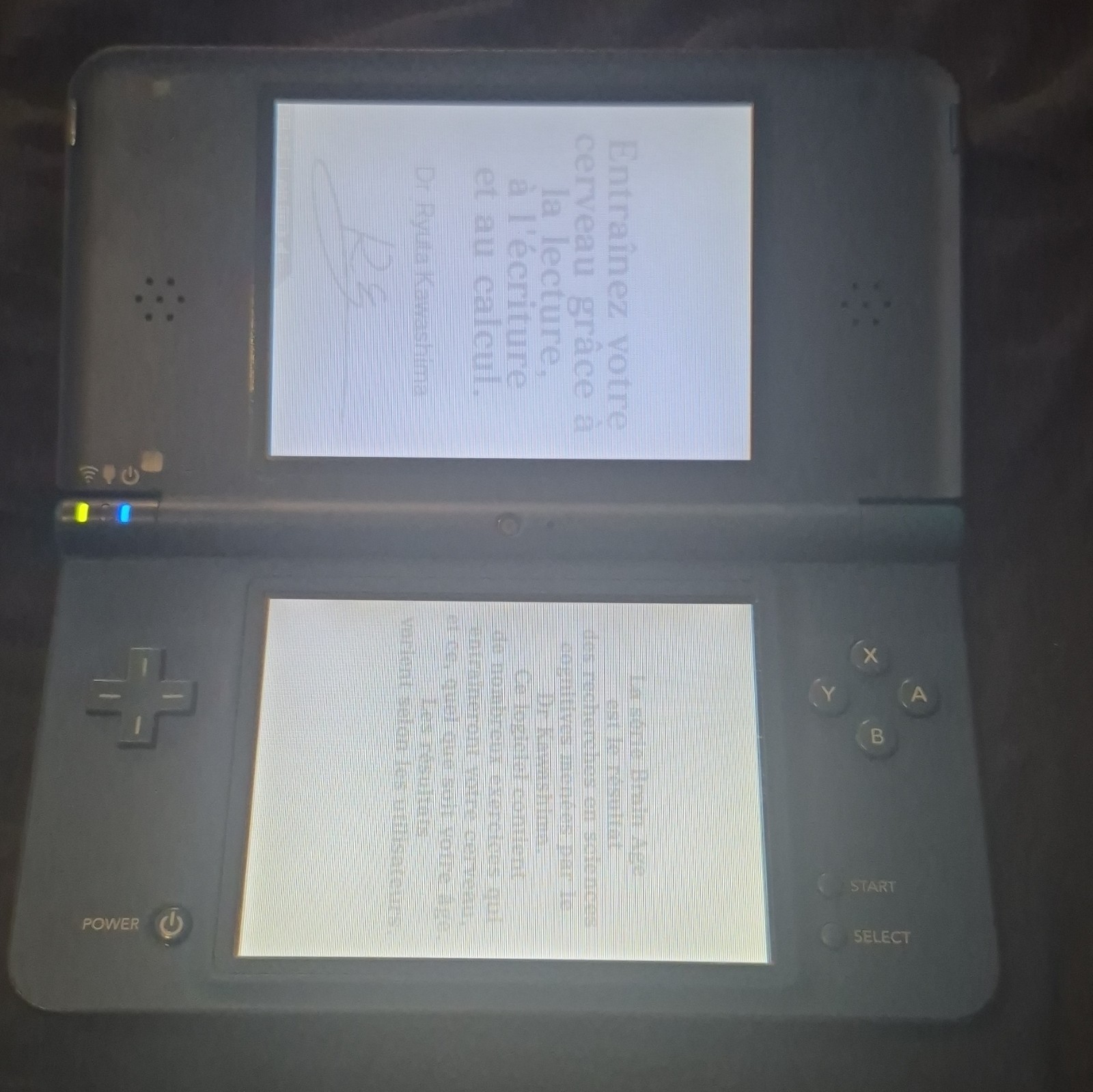 blue Nintendo DSi XL handheld console featuring a glossy Midnight Blue finish.