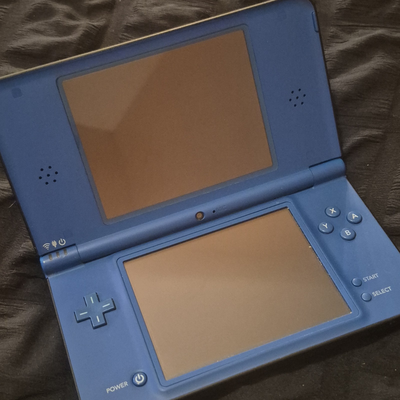 blue Nintendo DSi XL handheld console featuring a glossy Midnight Blue finish.