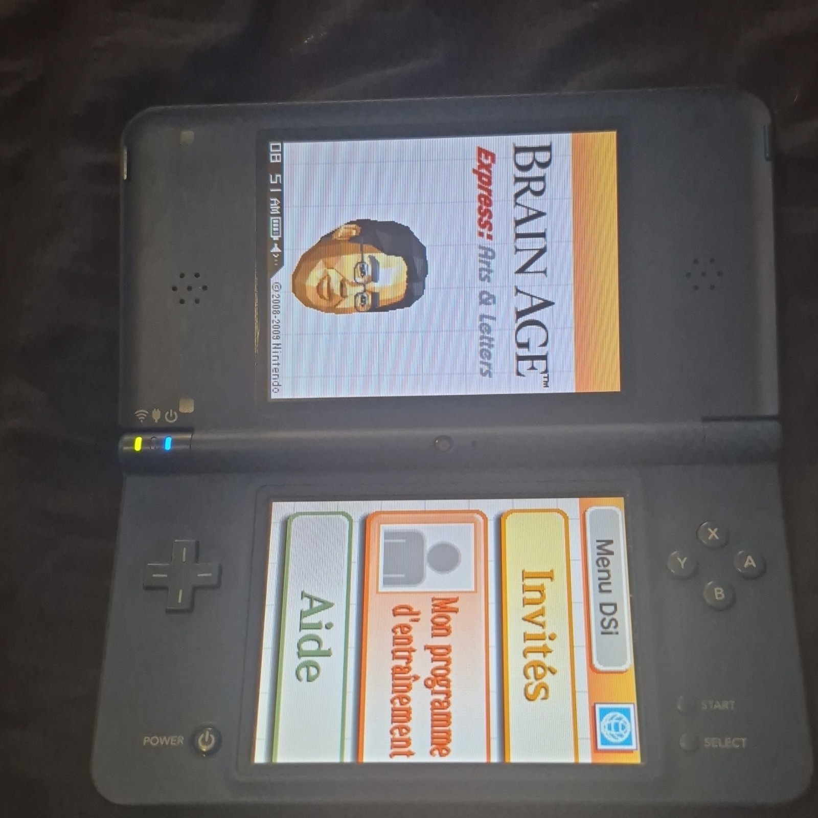 blue Nintendo DSi XL handheld console featuring a glossy Midnight Blue finish.