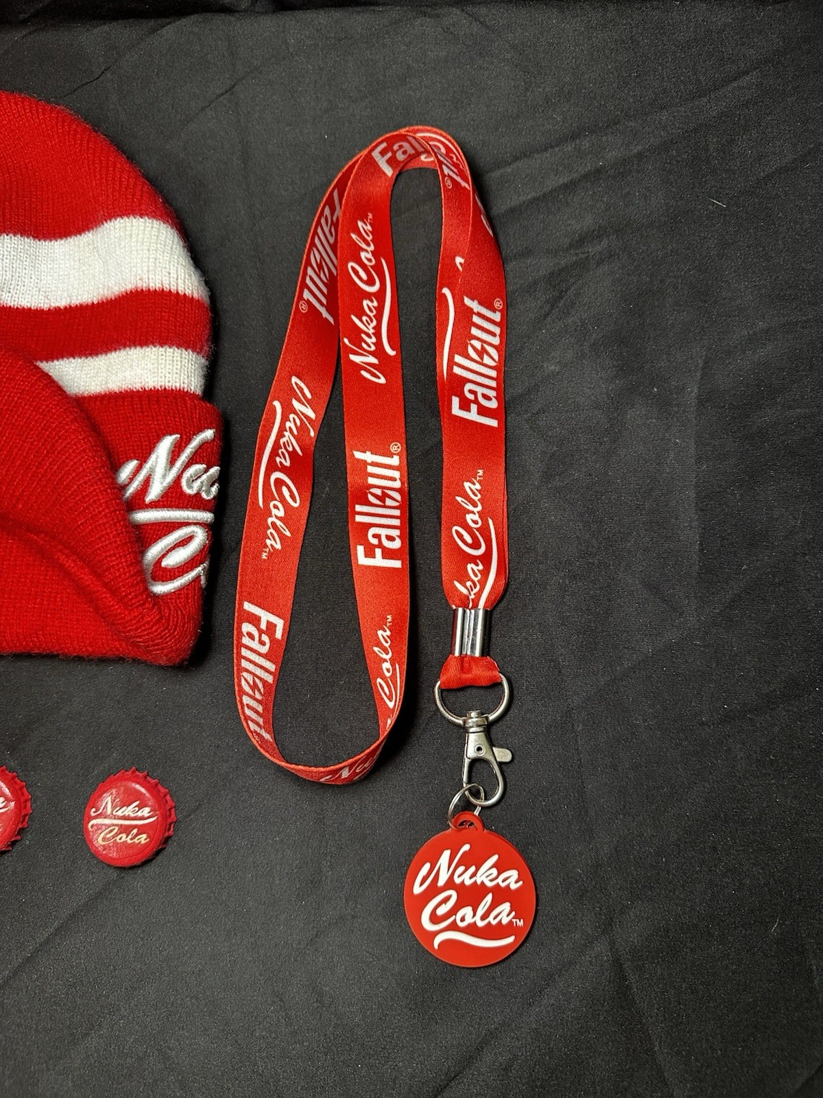 Lot of Bethesda Fallout Nuka Cola Bottle Caps, Beanie Hat, Lanyard & Keychain