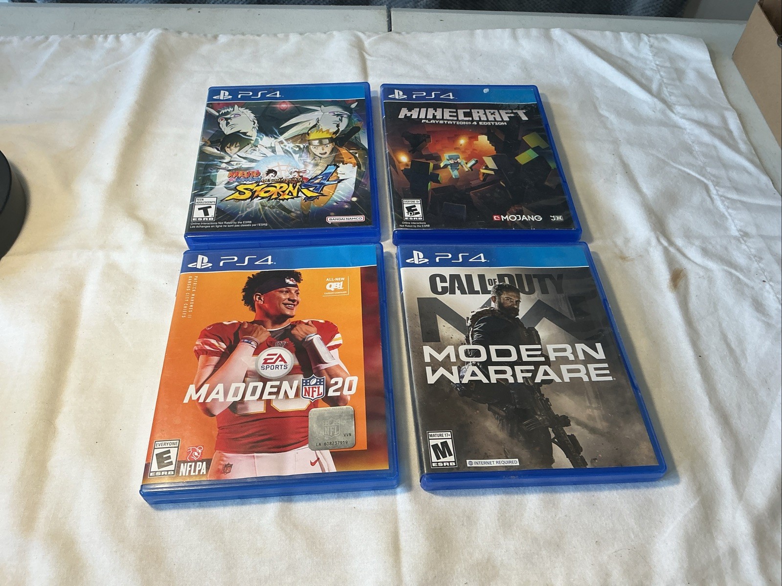 4 Play Station 4 Video Games.madden 20,modern Warfair,naruto Storm ,mind Craft.