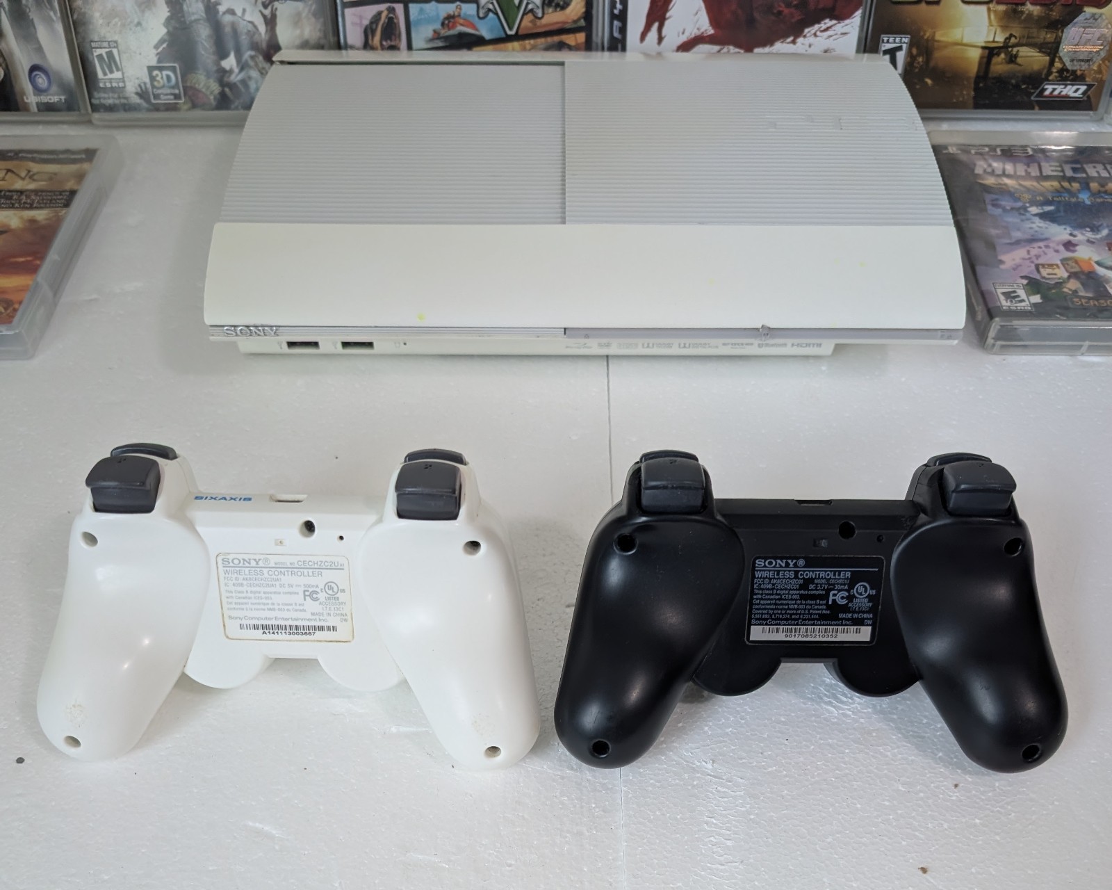 Sony PS3 Super Slim 500GB White Console Bundle 2 OEM Sony Controllers 8 Games…
