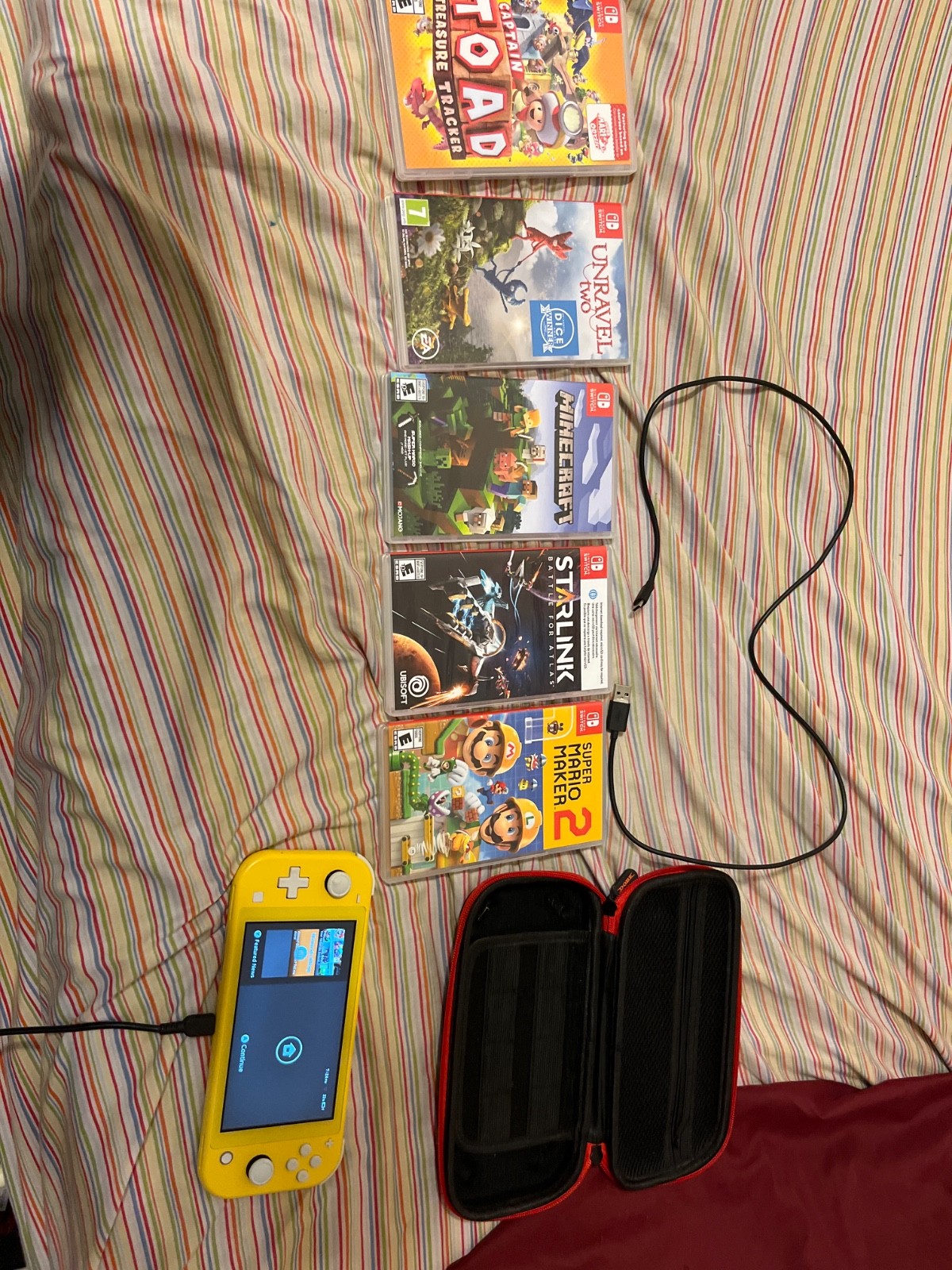 yellow nintendo switch lite with case and games