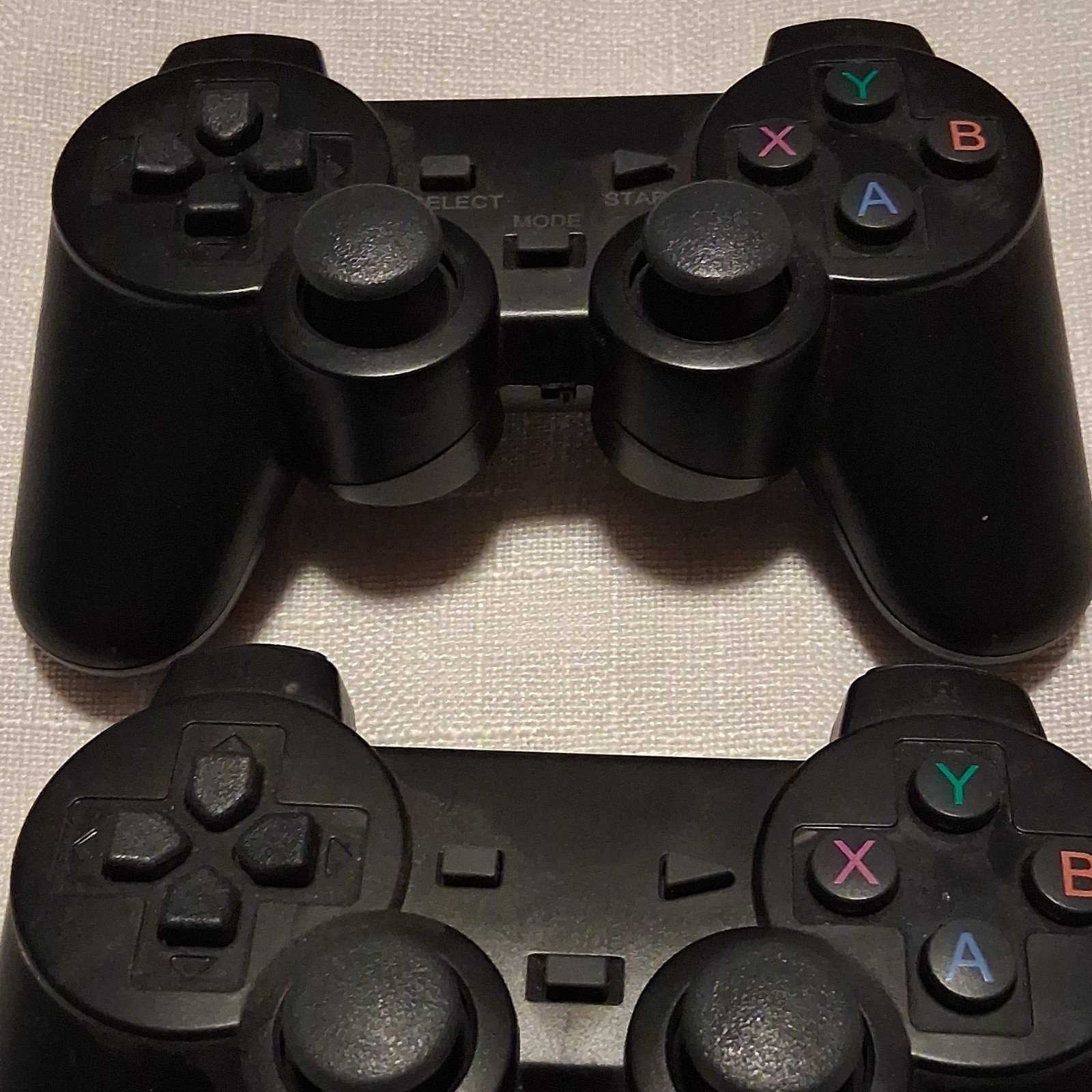 Lot of 2 Black Video Game Controllers with Dual Joysticks and XYAB Buttons
