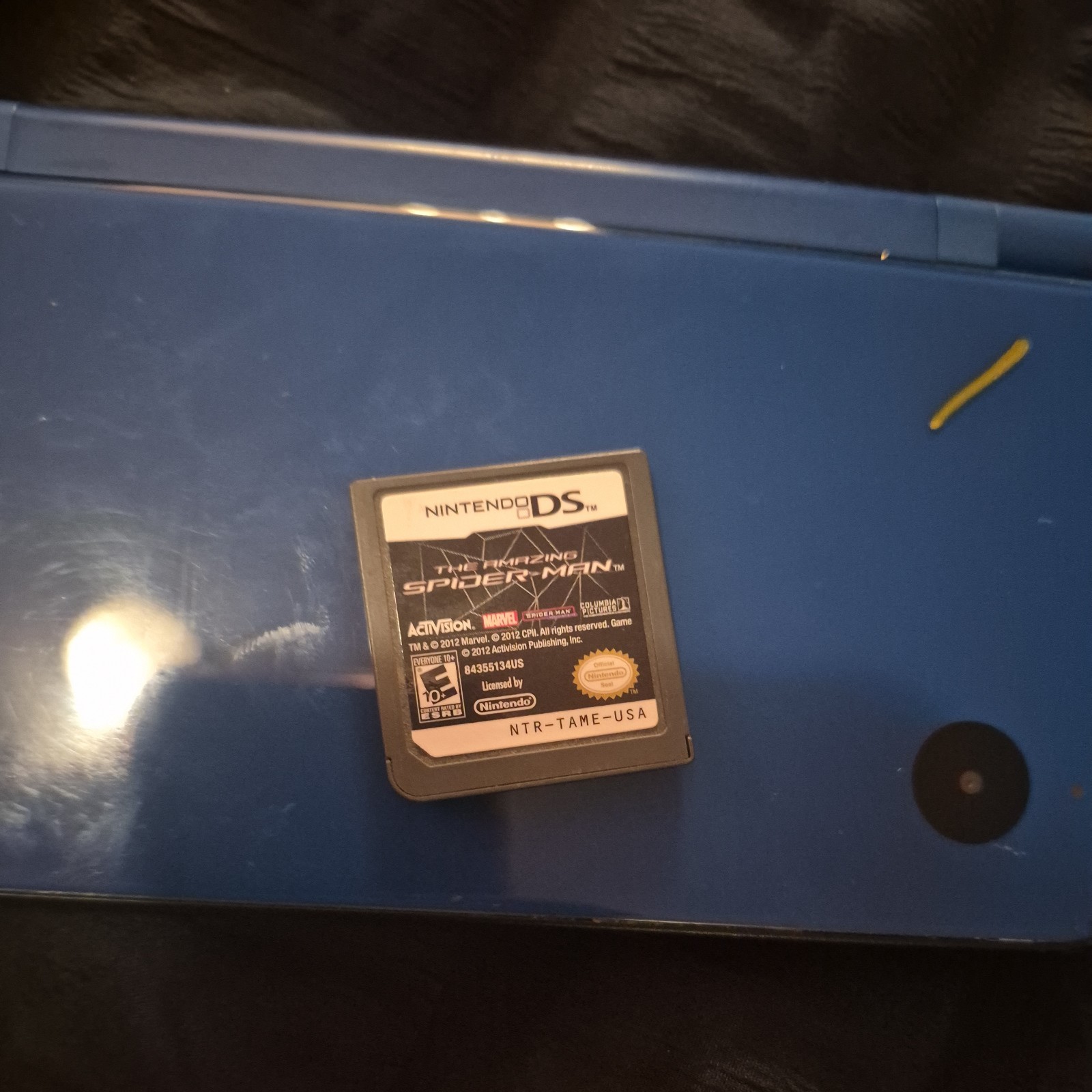 blue Nintendo DSi XL handheld console featuring a glossy Midnight Blue finish.