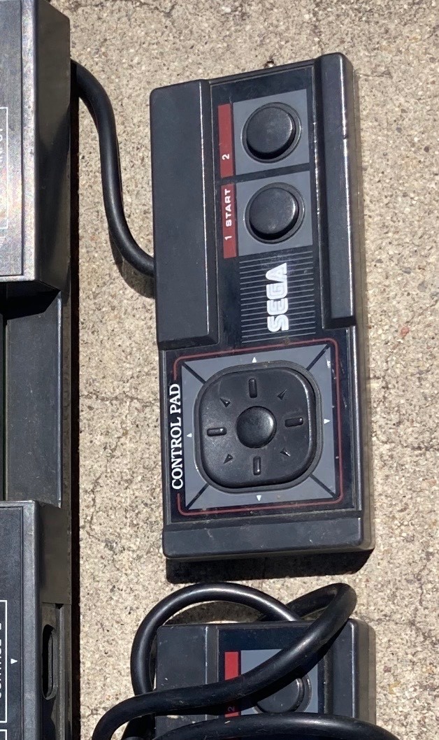 2 sega master system consoles with 3 controllers and games (not sure if it works