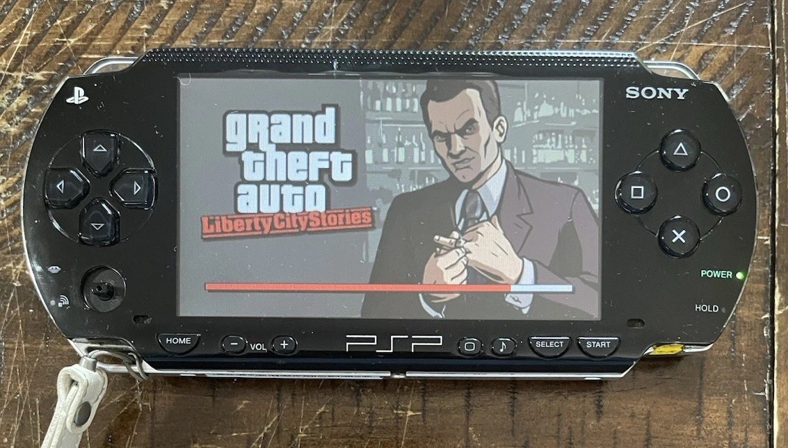 Sony PSP-1001 Console, 2 Batteries w/Charger, 4 Games, 2 Movies, Family Guy 1&2