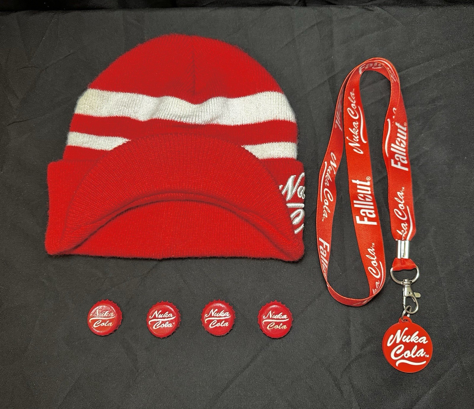 Lot of Bethesda Fallout Nuka Cola Bottle Caps, Beanie Hat, Lanyard & Keychain