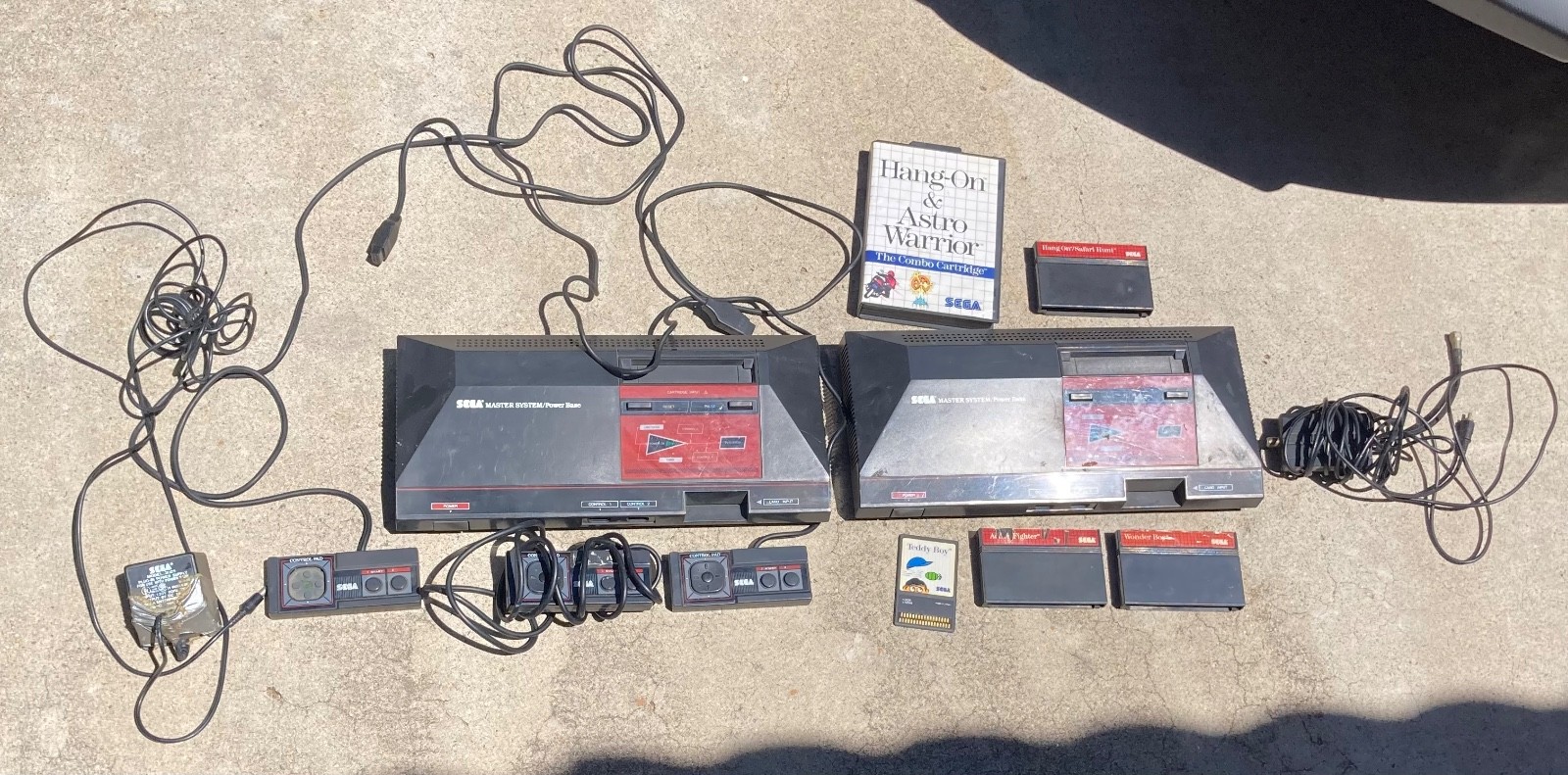 2 sega master system consoles with 3 controllers and games (not sure if it works