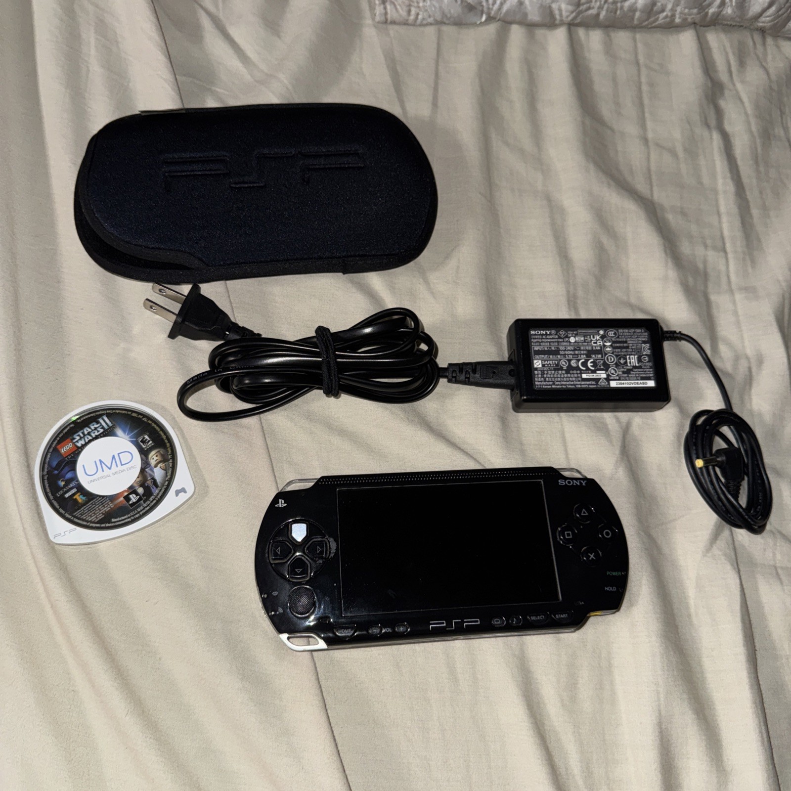 Sony PSP-1001 Handheld Game System Black with Case and charger
