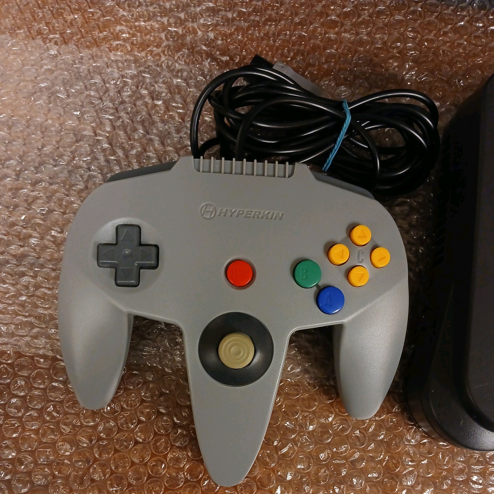 Nintendo 64 with expansion pak, power & AV cords, & one controller.