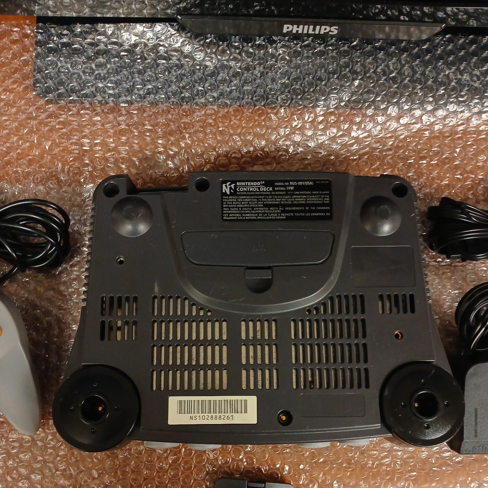 Nintendo 64 with expansion pak, power & AV cords, & one controller.