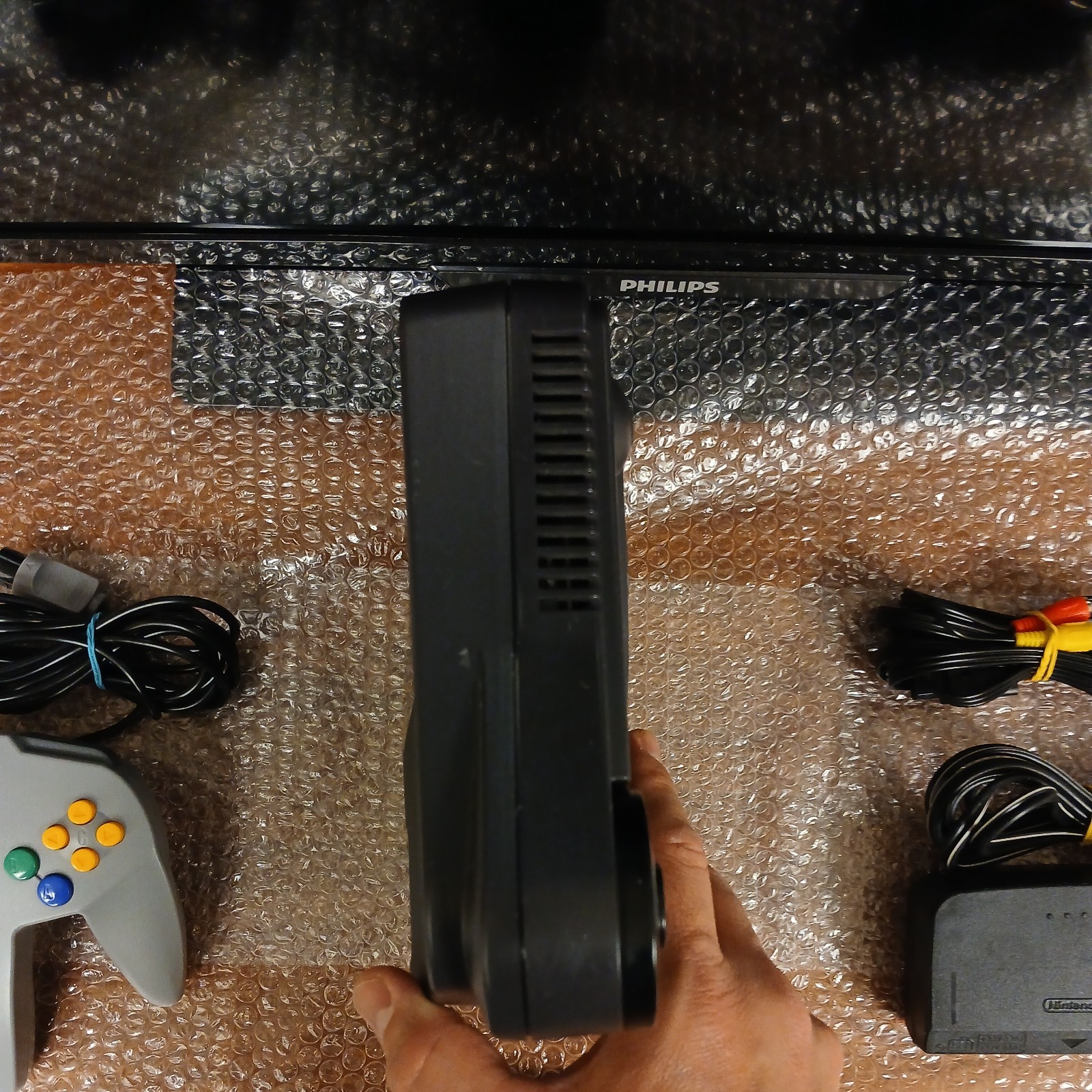 Nintendo 64 with expansion pak, power & AV cords, & one controller.
