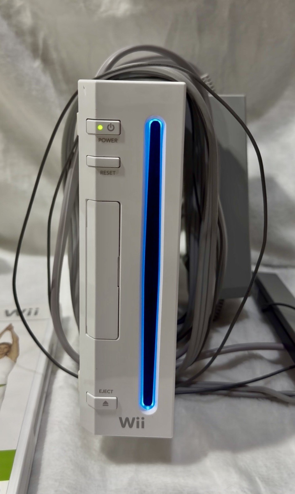 Nintendo Wii console with 2 remotes, 1 silicone sleeve & Nerf sports attachments