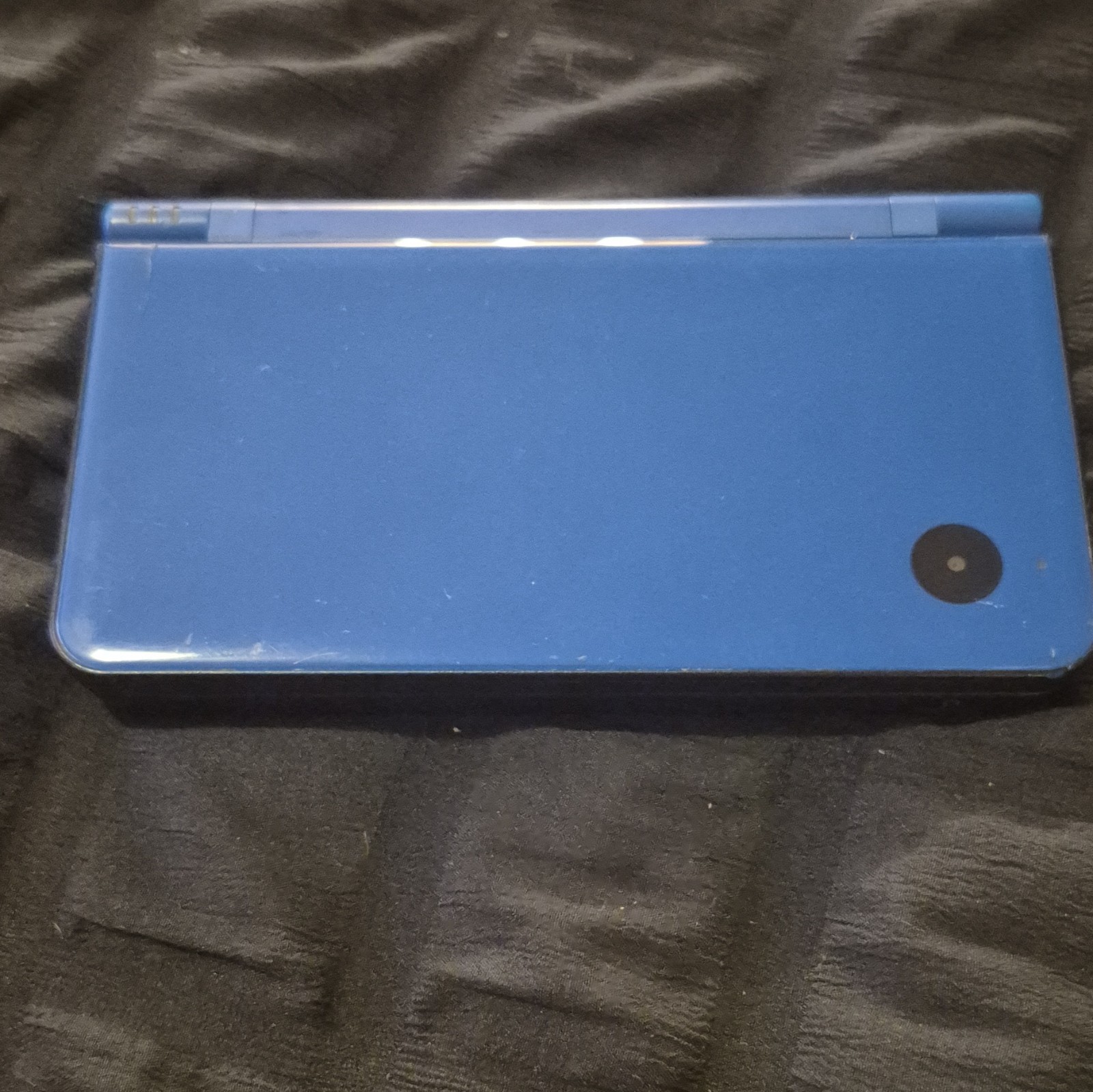 blue Nintendo DSi XL handheld console featuring a glossy Midnight Blue finish.