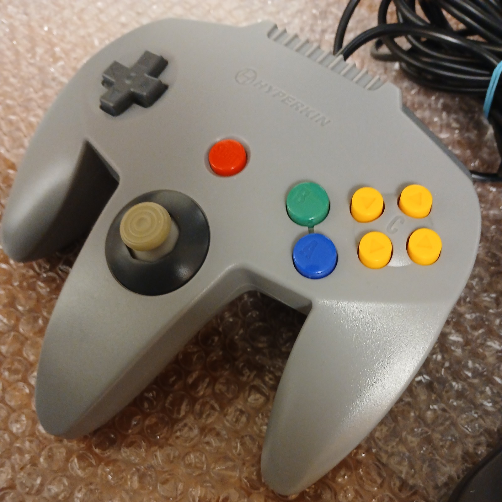 Nintendo 64 with expansion pak, power & AV cords, & one controller.